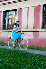 Image showing Retro girl on old bike