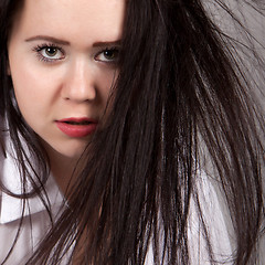 Image showing Disheveled long-haired woman in a white men's shirt