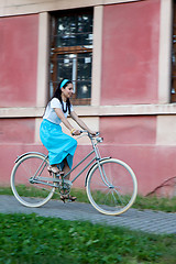 Image showing Retro girl on old bike