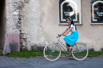 Image showing Retro girl on old bike