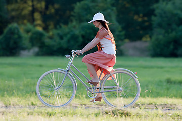 Image showing Retro girl on old bike