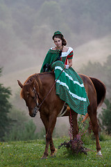 Image showing Girl riding equestrian classicism dress