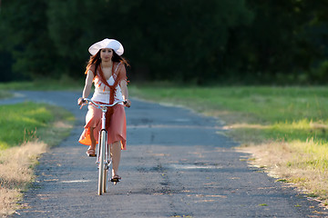 Image showing Retro girl on old bike