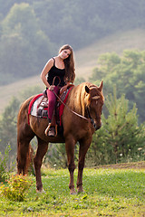 Image showing Young girl with a horse