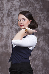 Image showing Girl with long hair in a white shirt and a blue vest