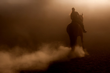 Image showing Horse riding in the dust