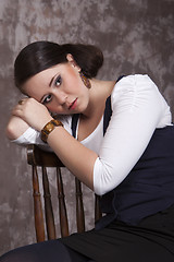 Image showing Girl with long hair in a white shirt and a blue vest