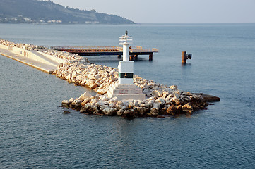 Image showing lighthouse and rock jetty breakwater