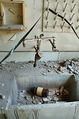 Image showing industrial sink with reel tape and bottle of chemical