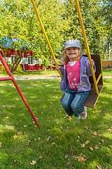 Image showing Smiling girl on swing