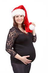 Image showing beautiful pregnant woman tenderly holding her tummy isolated on 