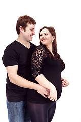 Image showing loving happy couple, smiling pregnant woman with her husband