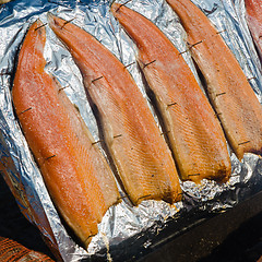Image showing salmon fillet roasted on coals, close-up