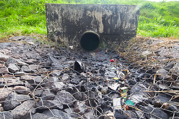 Image showing environmental pollution. engine oil from a pipe