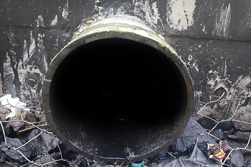 Image showing environmental pollution. engine oil from a pipe