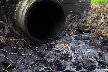 Image showing environmental pollution. engine oil from a pipe