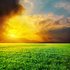 Image showing dramatic sunset over green grass field