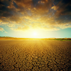 Image showing dramatic sunset over cracked desert