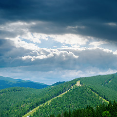 Image showing dramatic low clouds over green mountain