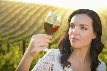 Image showing Young Adult Woman Enjoying A Glass of Wine in Vineyard