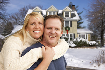 Image showing Couple in Front of Beautiful House with Snow on Ground