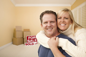 Image showing Couple in New House with Boxes and Sold Sale Sign