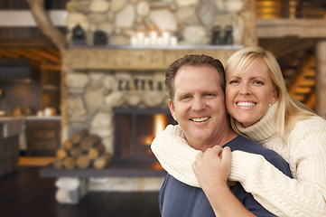 Image showing Affectionate Couple at Rustic Fireplace in Log Cabin