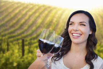 Image showing Young Woman Enjoying Glass of Wine in Vineyard With Friends