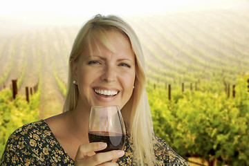 Image showing Attractive Woman Enjoying a Glass of Wine at the Vineyard