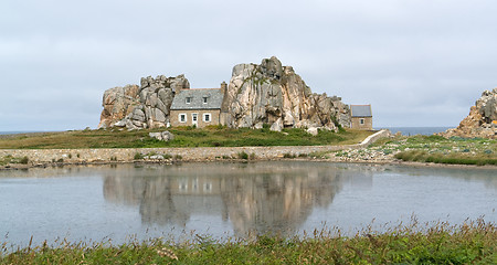 Image showing house between rock formation