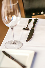 Image showing elegant dinner table set with knife fork and wine glass