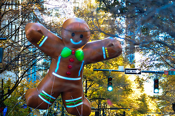 Image showing ginger bread cookie inflatable floating thru city streets