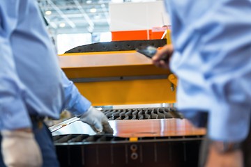 Image showing Machine cutting steel in a factory