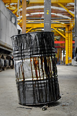 Image showing Damaged oil drums in industrial interior