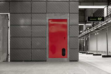 Image showing Gray steel wall with the red door