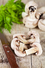 Image showing  fresh sliced champignons with parsley and old knife
