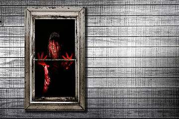 Image showing Image of Bleeding Woman in Window