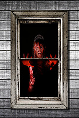 Image showing Image of Bleeding Woman in Window