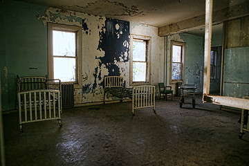 Image showing Delapidated Hospital Building With Empty Rusted Beds