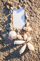 Image showing sailing boat and seashell in sand decoration closeup