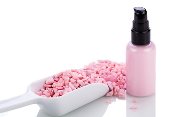 Image showing pink body lotion in dispenser and aroma salt isolated