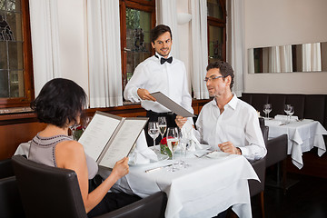 Image showing young smiling couple at the restaurant 