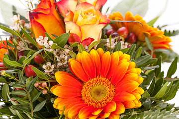 Image showing Vivid orange gerbera daisy in a bouquet