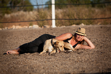 Image showing young woman training horse outside in summer