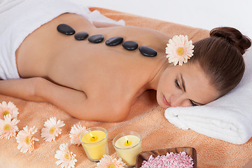 Image showing young attractive woman get hot stone massage 