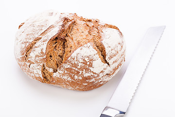 Image showing fresh baked grain bead and knife isolated