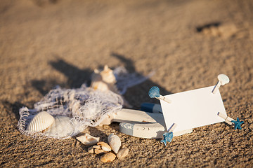 Image showing sailing boat and seashell in sand decoration closeup