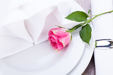 Image showing Table setting with a single pink rose