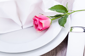 Image showing Table setting with a single pink rose