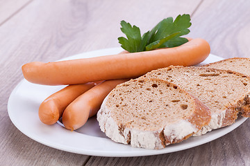 Image showing tasty sausages frankfurter with grain bread 